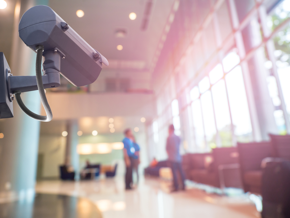 CCTV camera watching two people in building.